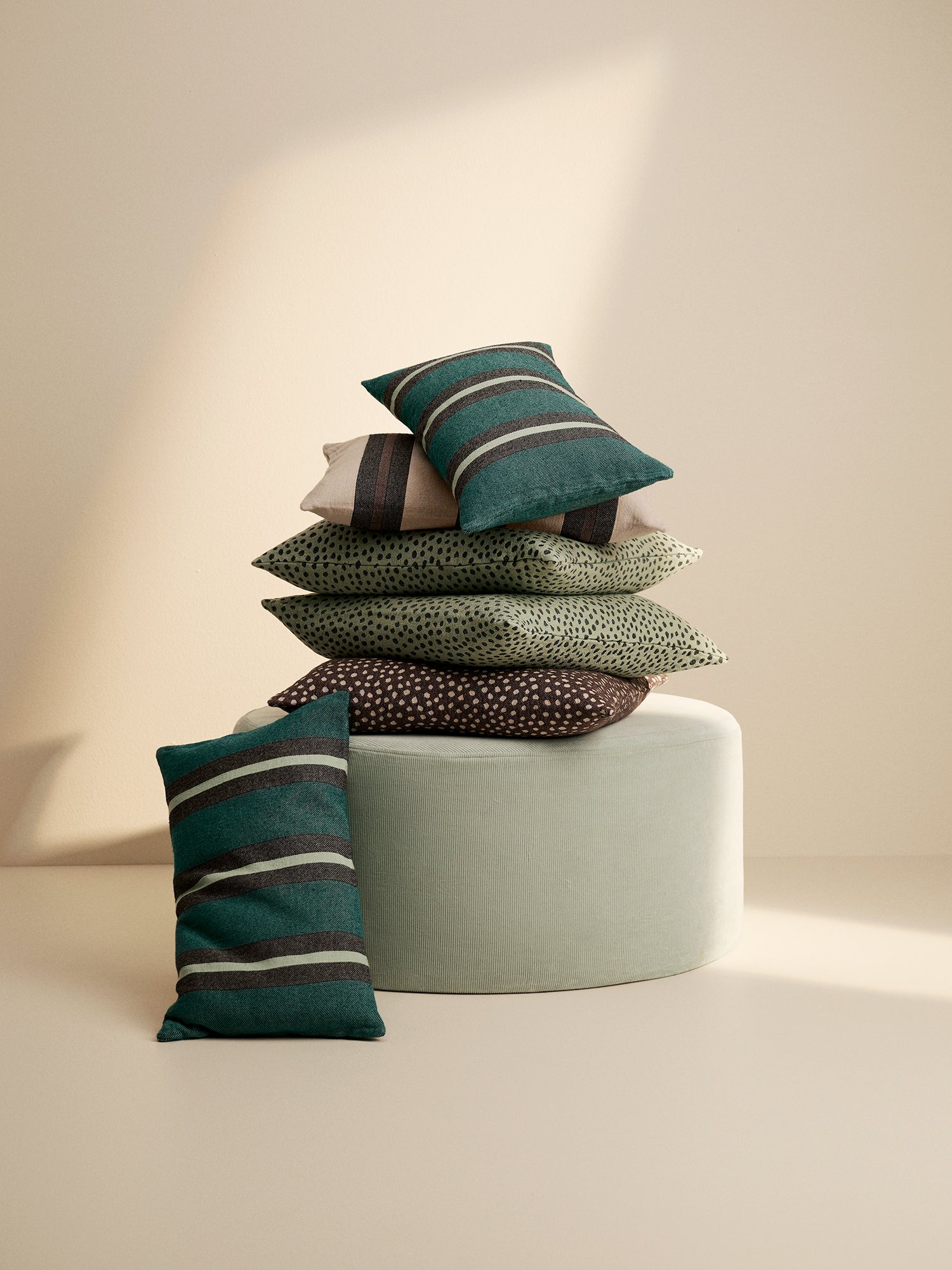 Nanso Home textiles, throw pillows in a pile in a stylish home decor picture.