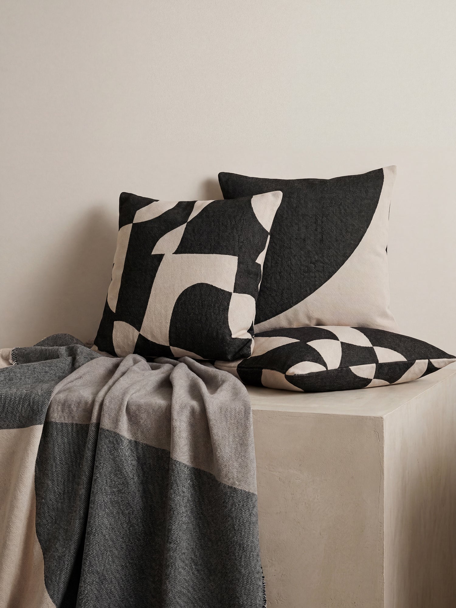 Nanso beautiful Art blanket with a neutral toned stylish pattern woven using jacquard technique, pictured in a beautiful home decor setting with throw pillows.