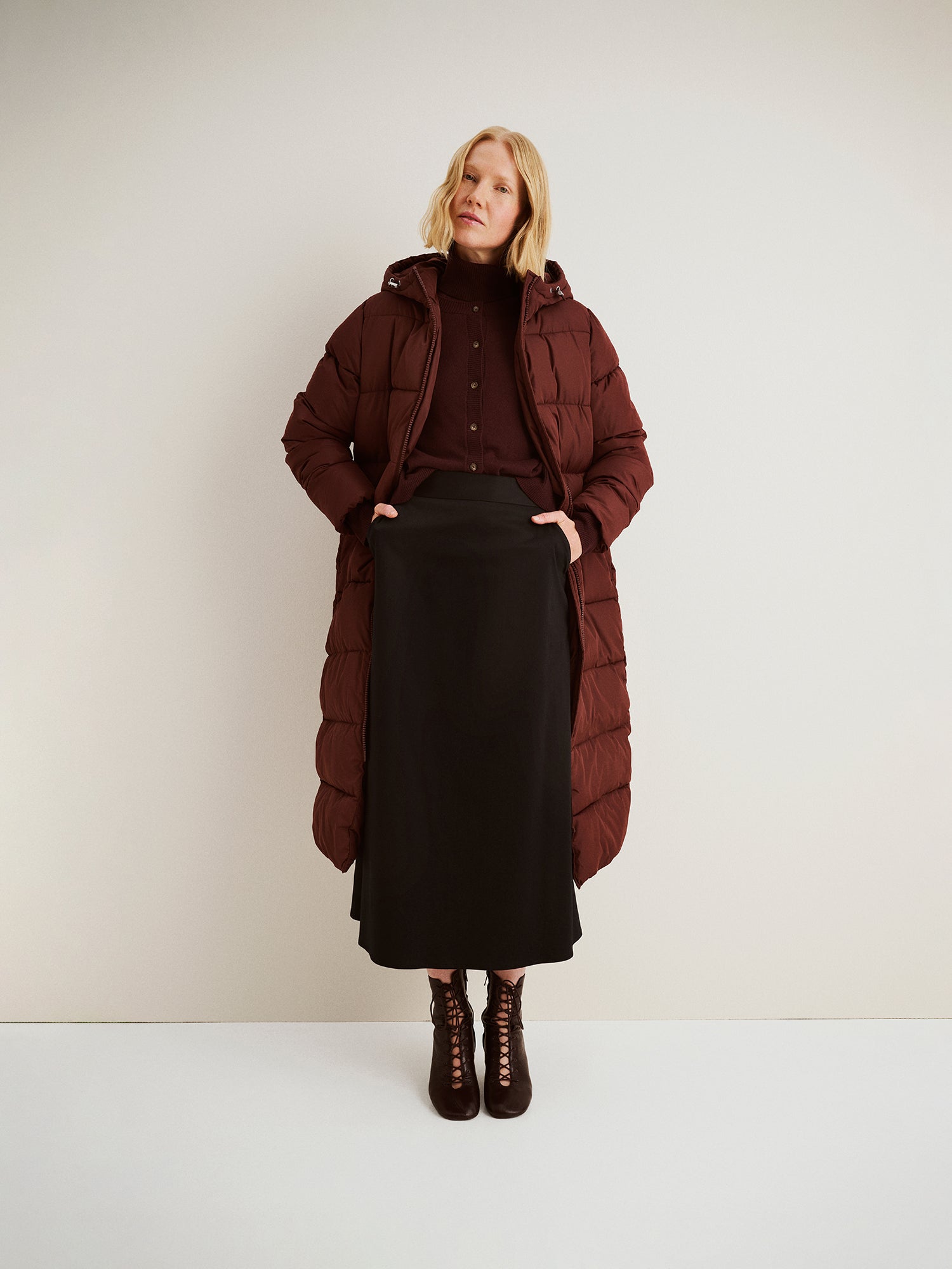 The Lumi Long Pink Puffer Coat in beige offers cozy warmth with its lightweight, puffy insulation. 