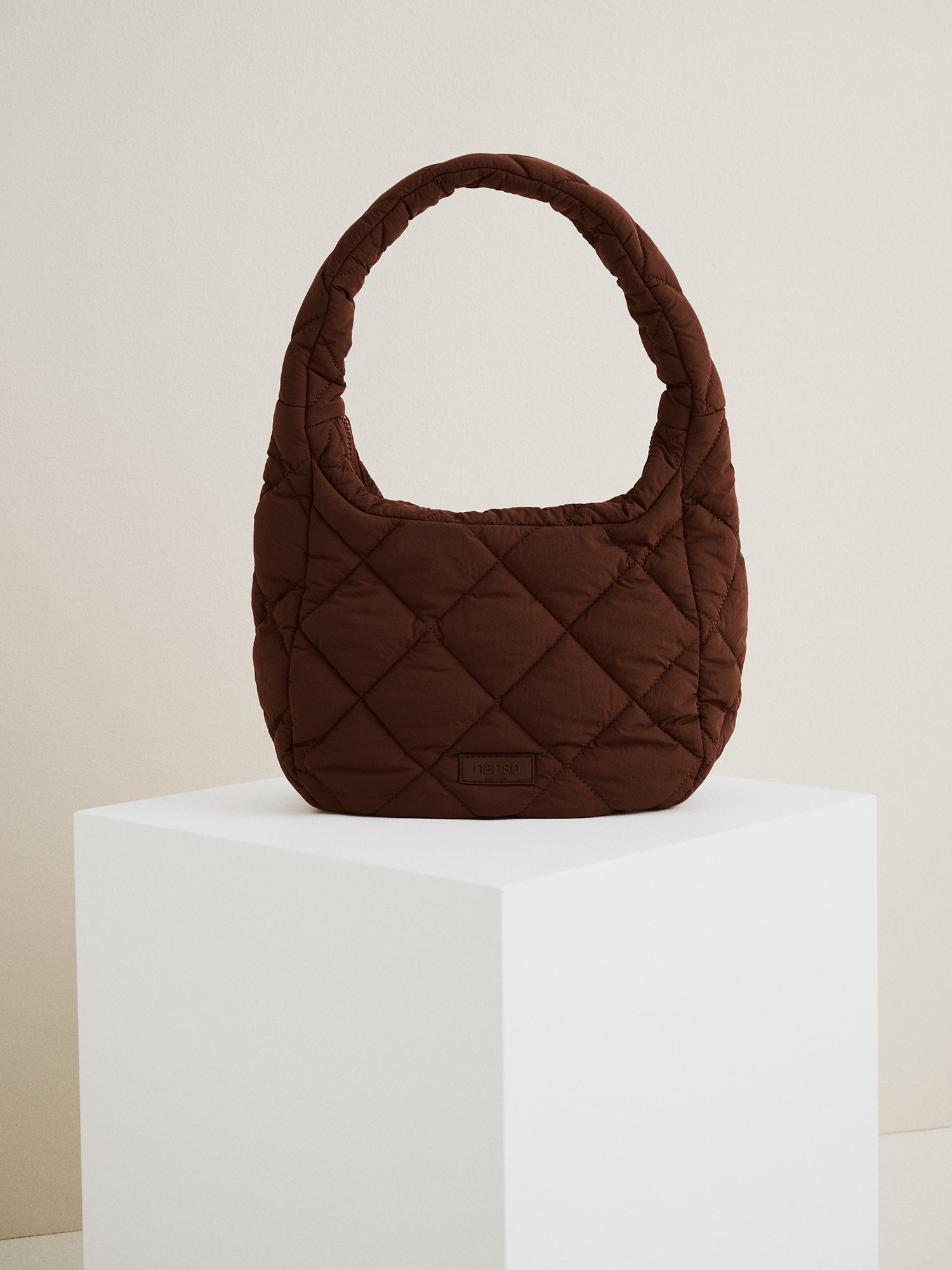 Nanso's trendy dark brown Midi Vanu bag is crafted from quilted fabric, front