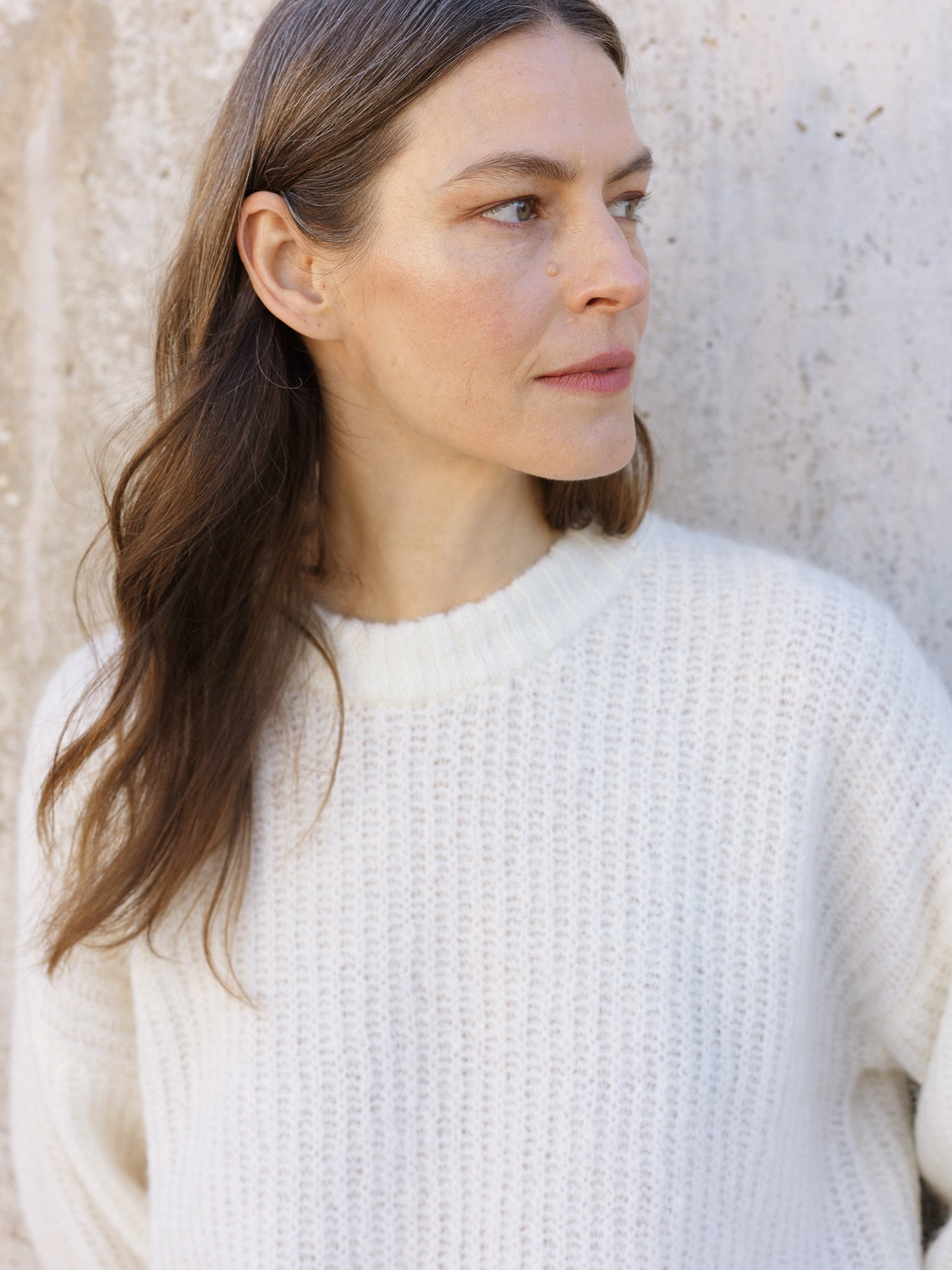 Nanso's luxurious off-white Karamelli knit sweater for women features a round neckline, close-up