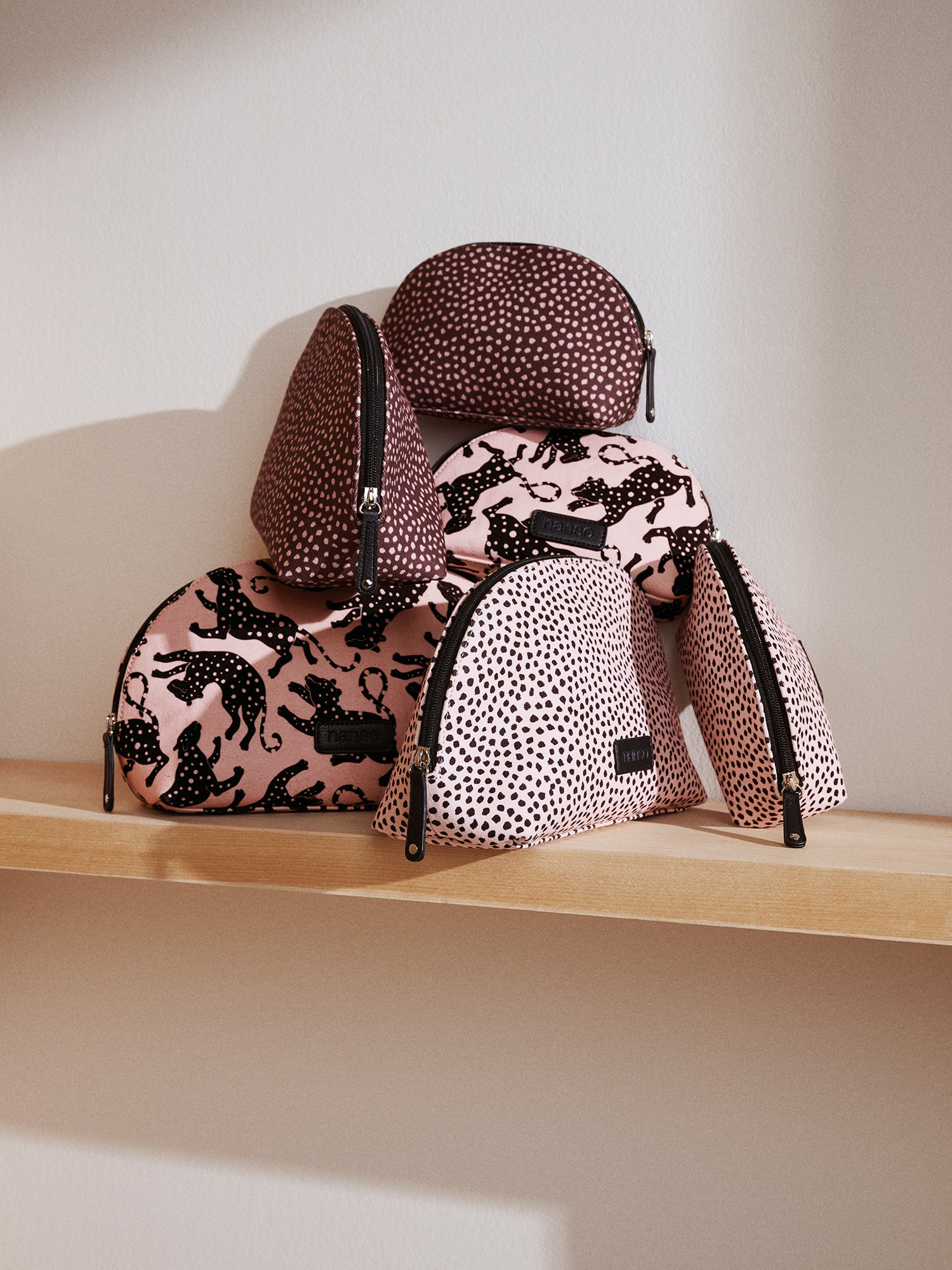 Nanso's beige Leonora mini cosmetics bag features a lively leopard print and a compact size.