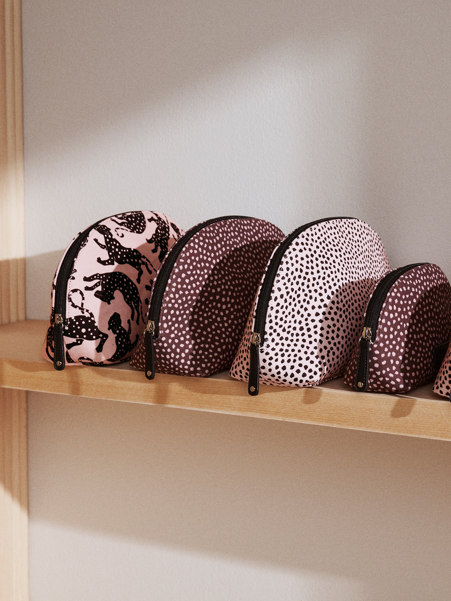 Nanso's beige Muru cosmetics bag features a charming delicate polka dot pattern fon a shelf