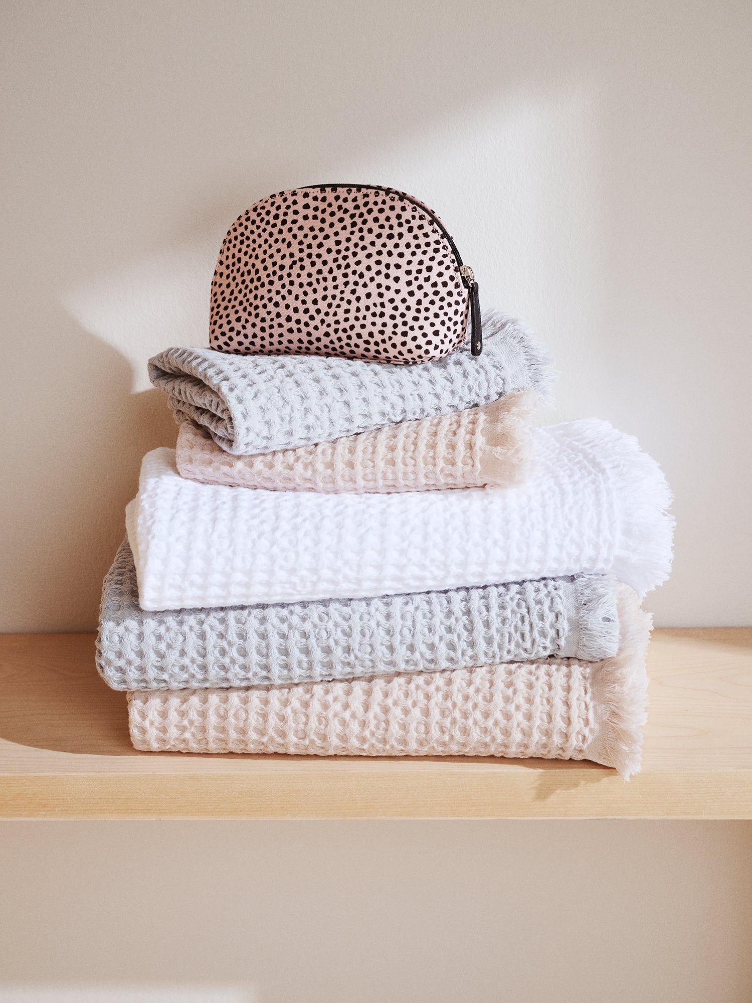 Nanso's beige Muru mini cosmetics bag features a charming delicate polka dot pattern on a pile