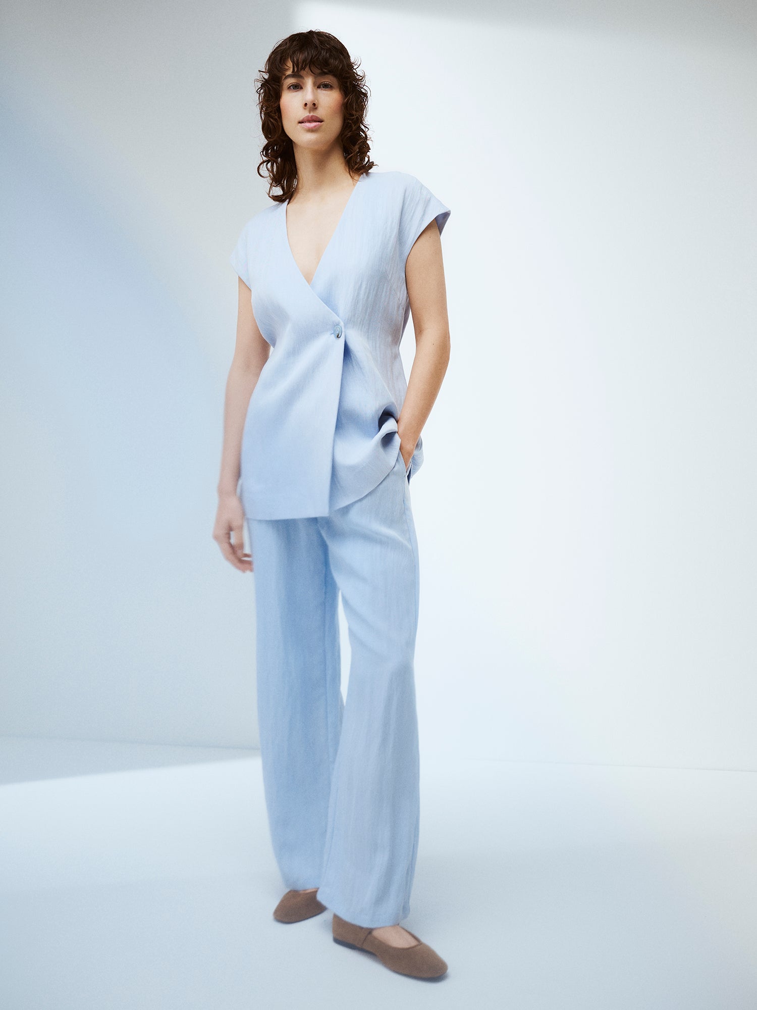 Nanso Nizza trousers in a sophisticated blue shade on a model with a matching waistcoat.