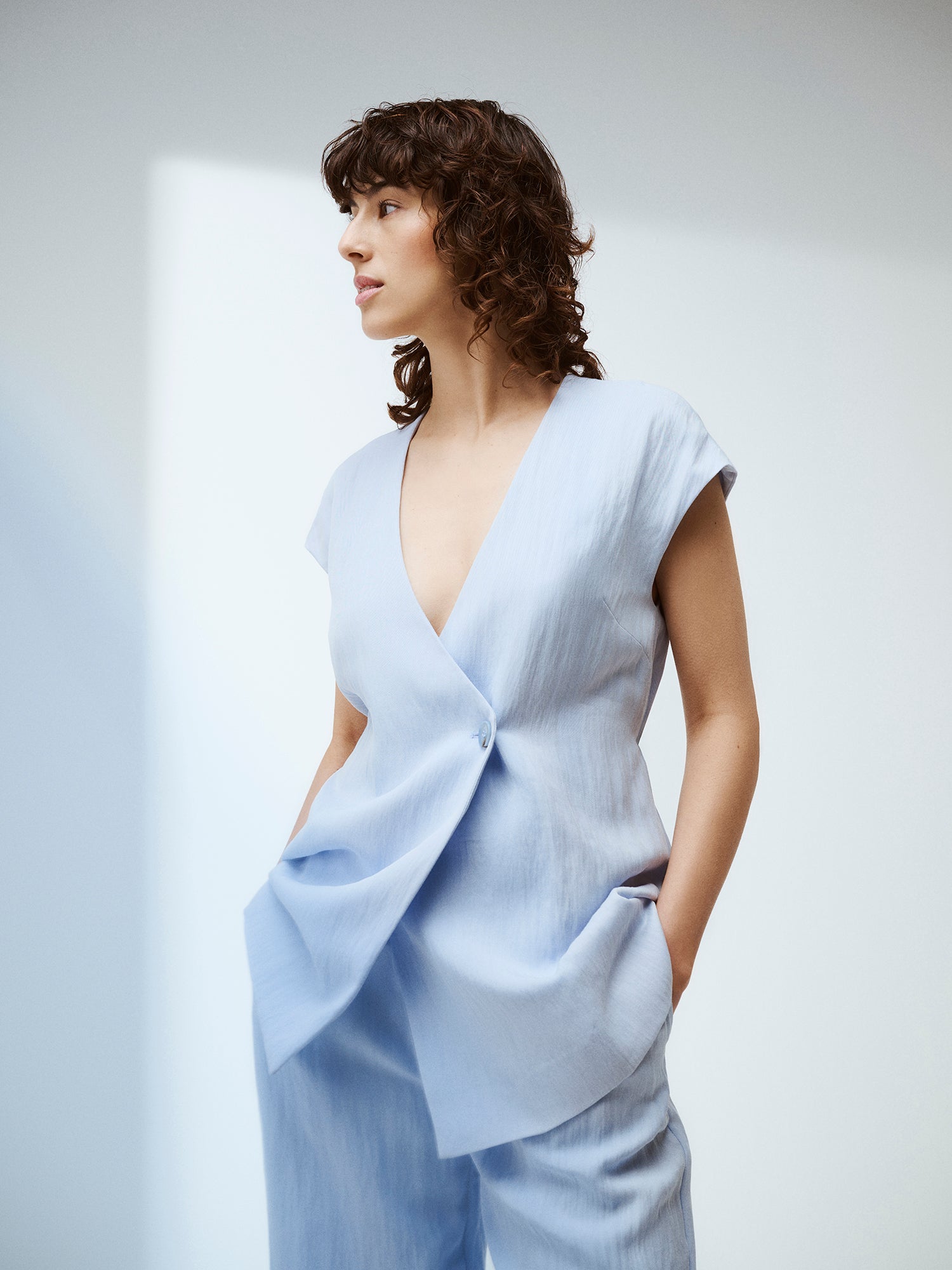 Nanso sophisticated blue waistcoat from the NIZZA collection on a model with matching trousers.