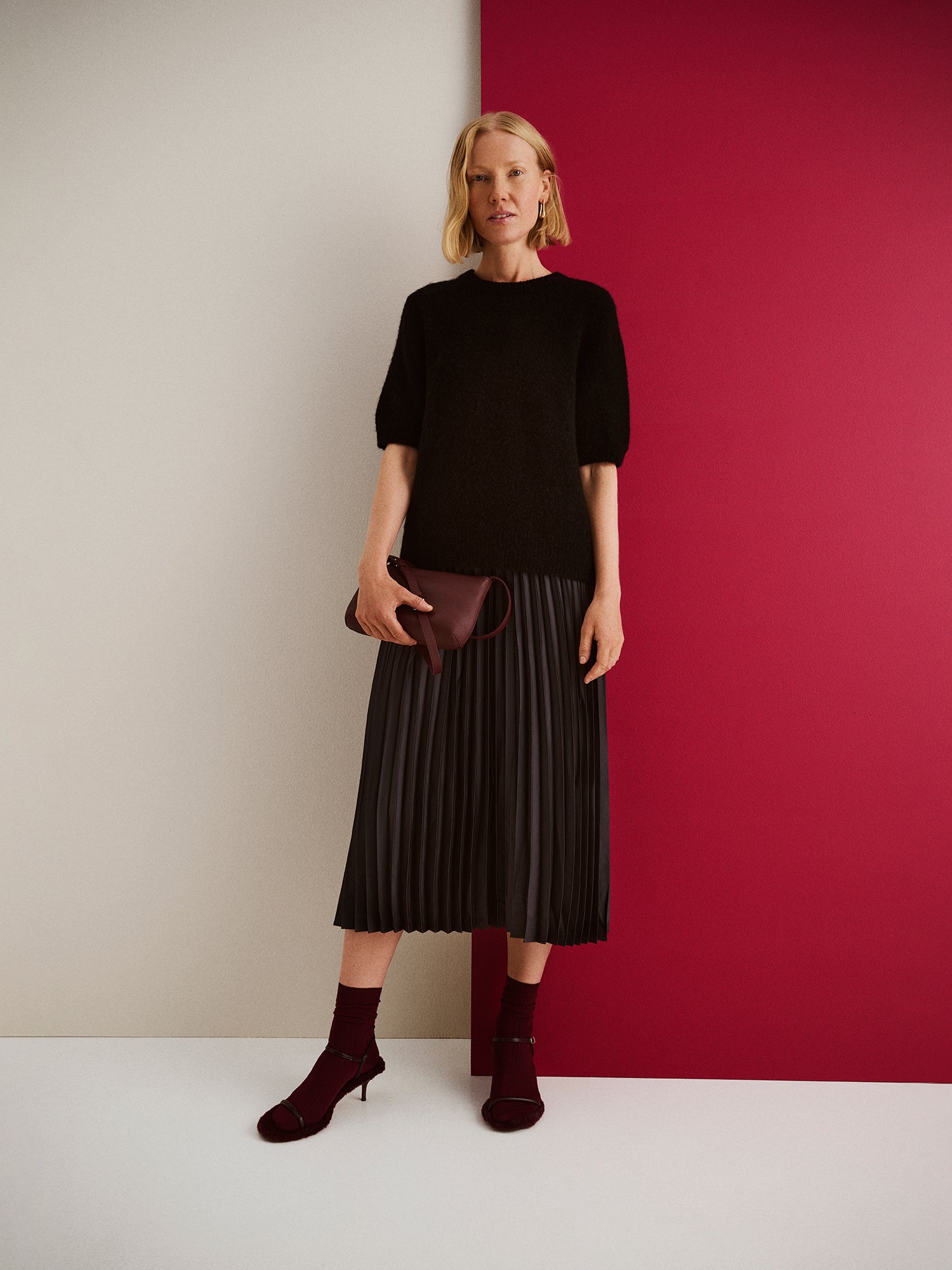 Nanso's elegant Taite skirt for women features a graceful drape in a classic black with a clutch