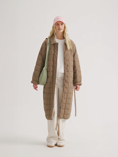 Woman wearing the MARJE Quilted Coat in beige