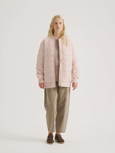 Woman wearing the MERJE Quilted Bomber Jacket in Light Rose