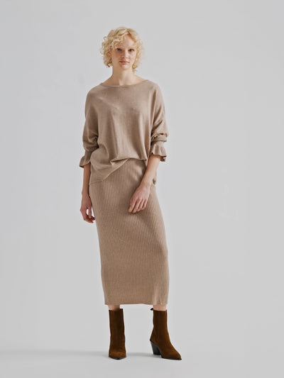 Nanso women's simply stylish and lightweight Villis Frilla knit jumper is charmingly finished with beautiful frill details at the cuffs, pictured on a model with a matching knit skirt